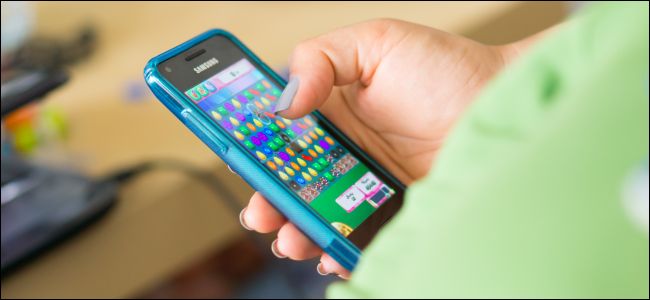 A person playing Candy Crush Saga on a Samsung Android smartphone.