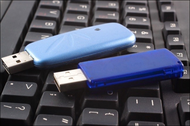 Two USB devices over a black keyboard