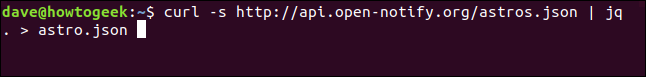 The "curl -s http://api.open-notify.org/astros.json | jq . > astros.json" command in a terminal window.