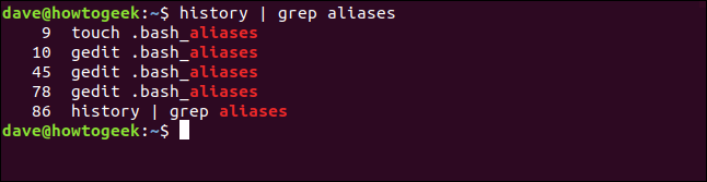 The "history | grep aliases" command in a terminal window.