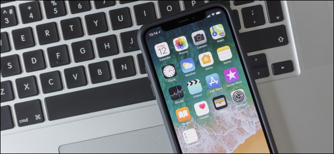 An iPhone sitting on a MacBook keyboard