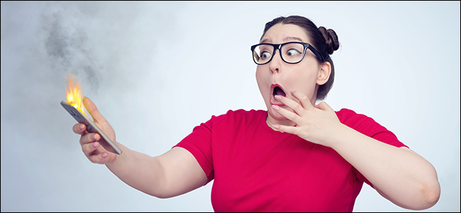 A girl freaking out while holding an exploding phone. Clearly, she didn't use a Qi-Certified wireless charger.