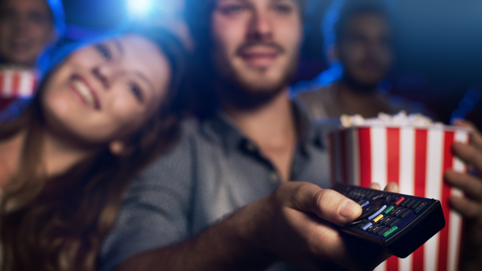 Couple watching TV with popcorn