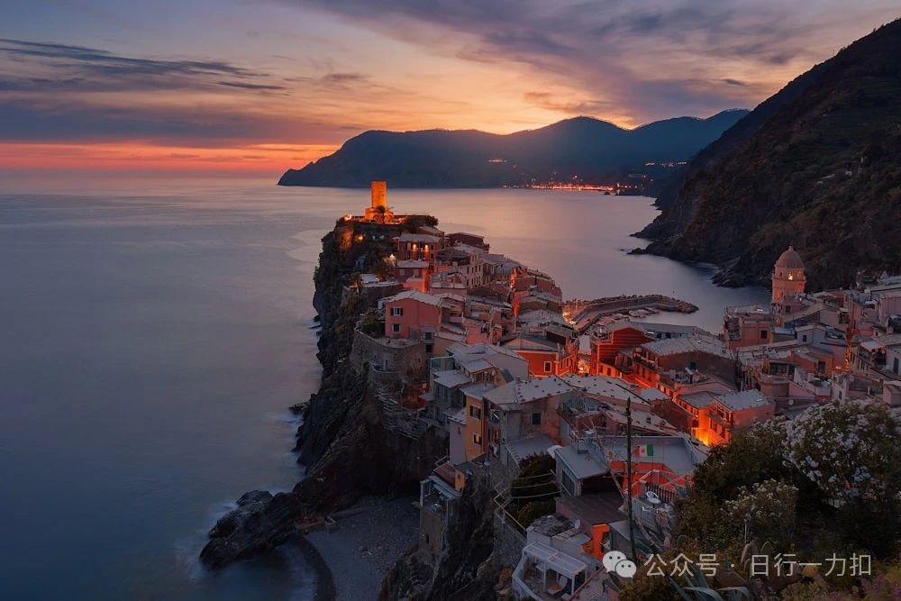 aerial view of village on mountain cliff during orange sunset