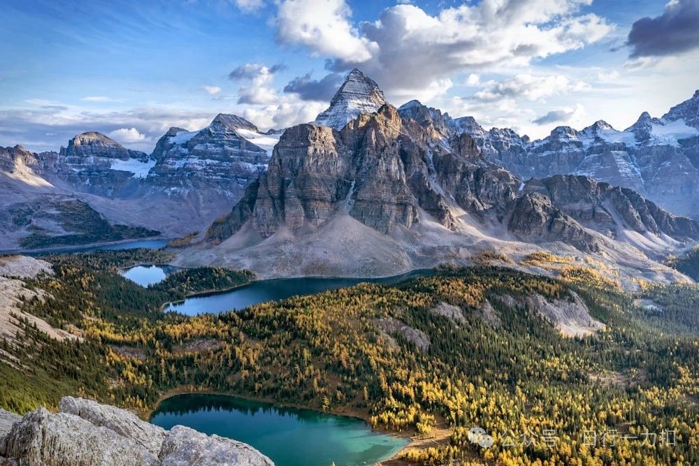 a mountain range with a lake in the foreground