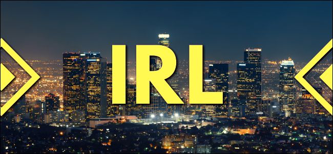 The initialism "IRL" superimposed over a Los Angeles cityscape.