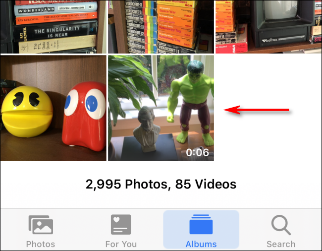 Tap a video in Photos to select it on iPhone