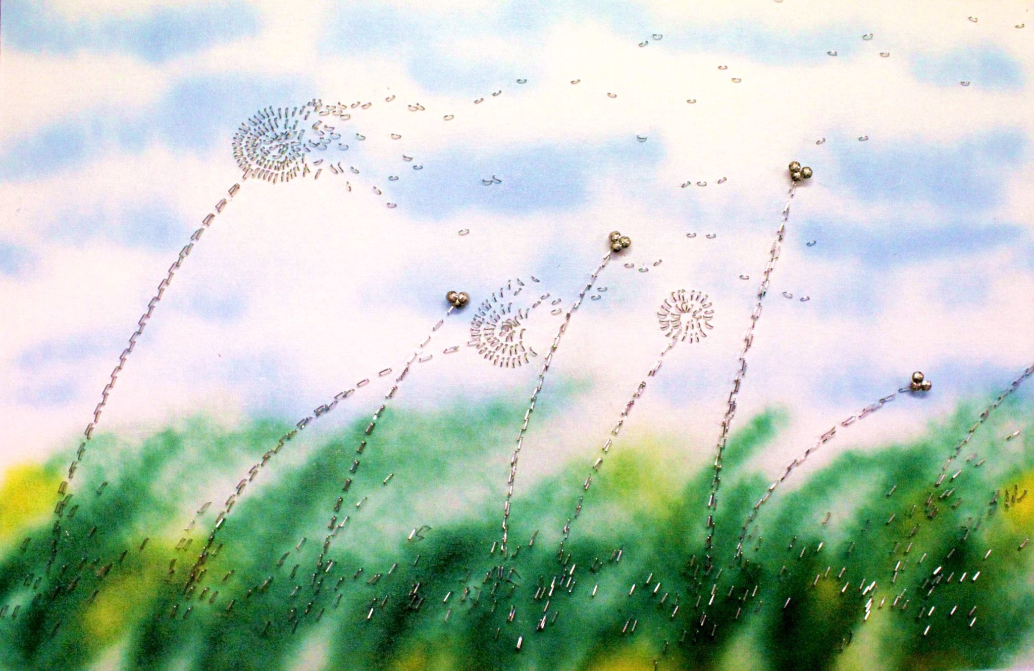 field with dandelions made of staples and thumbtacks blowing in