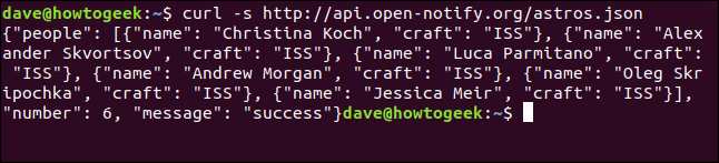 The "curl -s http://api.open-notify.org/astros.json" command in a terminal window.