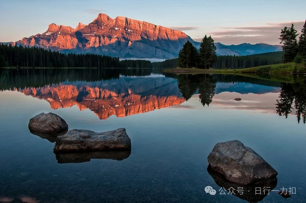 mountain reflection on body of water