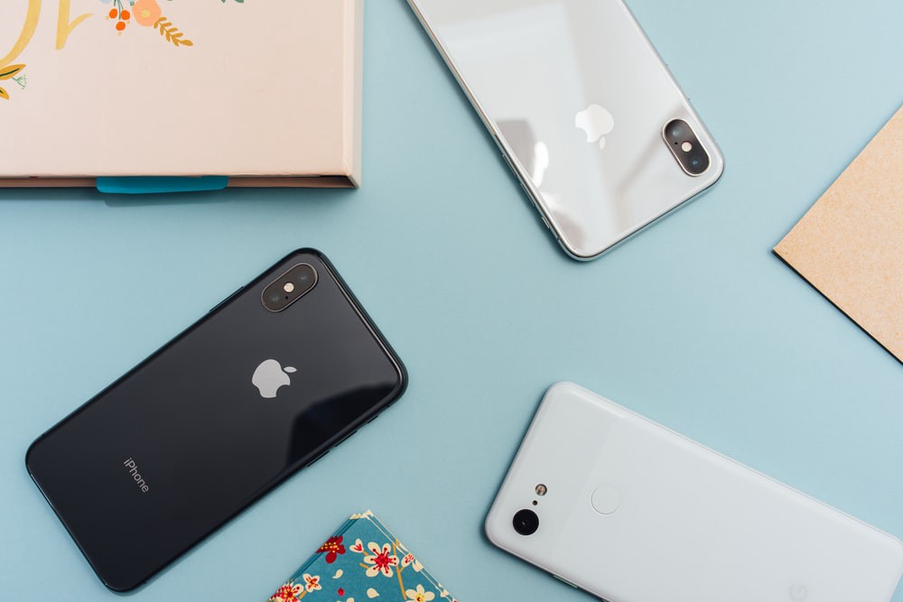 iPhones and Pixel 2 on a blue table